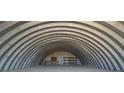 Large, arched metal building with an open interior featuring shelving units at 1180 Lava Ave, Jean, NV 89019