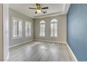 Stylish bedroom with hardwood floors, tray ceiling, and ample natural light creating a serene and comfortable space at 12116 Vista Linda Ave, Las Vegas, NV 89138