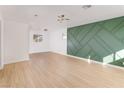 Spacious living room with luxury vinyl plank flooring and modern accent wall at 1436 Chestnut St, Henderson, NV 89011