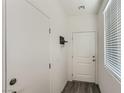 Bright entryway featuring a white door and modern wood-look flooring at 1611 Prairie Fields Ct, Las Vegas, NV 89115