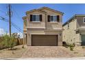 Inviting two-story home with a spacious two-car garage and desert landscaping at 1611 Prairie Fields Ct, Las Vegas, NV 89115