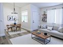 Open-concept living room with modern light fixtures and a dining space nearby at 1624 N Torrey Pines Dr # 101, Las Vegas, NV 89108