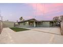 Picture of a well maintained backyard with green grass and a large concrete patio, perfect for entertaining at 1628 Izabella Ave, Las Vegas, NV 89169