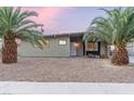 Cozy single-story home with desert landscaping and mature palm trees offering curb appeal at 1628 Izabella Ave, Las Vegas, NV 89169