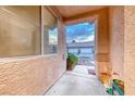 View from the covered entryway looking out towards the garages and desert landscaping at 200 Teller St, Henderson, NV 89074