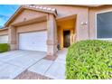 Inviting single story home featuring an attached garage, covered entryway and well-manicured landscaping at 200 Teller St, Henderson, NV 89074