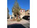 Lovely two-story home boasts desert landscaping, red shutters, a private driveway, and an attached garage at 2190 Clancy St, Las Vegas, NV 89156