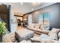 Living room featuring plush seating, modern decor, and an open layout to the kitchen at 363 Silva Pl, Henderson, NV 89011