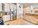 Bright kitchen with stainless steel appliances, granite countertops, and white cabinetry at 42 Glade Water Dr, Henderson, NV 89052