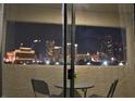 Balcony view of city skyline at night with table and chairs at 4200 S Valley View Blvd # 3074, Las Vegas, NV 89103