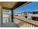 View from a balcony of a community with two-story homes, block walls, and desert landscaping at 4240 Spring Storm Ave, North Las Vegas, NV 89081