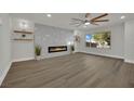 Bright and airy living room with a modern fireplace, wood-look floors, and ample natural light at 4637 Balfour Dr, Las Vegas, NV 89121