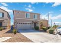 Two-story home features desert landscaping, a two-car garage, and a well-maintained front yard at 4976 Quiet Morning St, Las Vegas, NV 89122