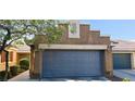 A well-maintained two-car garage complements the neutral stucco exterior for a clean and modern curb appeal at 5045 Bayberry Crest St, North Las Vegas, NV 89031
