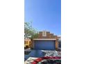 The home features a two-car garage and neutral stucco exterior for a clean and modern curb appeal at 5045 Bayberry Crest St, North Las Vegas, NV 89031