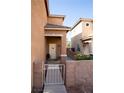 Inviting entrance with security gate, leading to the front door of this lovely home at 5216 Loma Verde Ave, Las Vegas, NV 89108