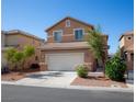 Inviting two-story home featuring a two-car garage, desert landscaping, and a welcoming facade at 5216 Loma Verde Ave, Las Vegas, NV 89108
