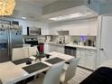 Bright eat-in kitchen featuring white cabinets, stainless steel appliances and modern finishes at 5474 S Maryland Pkwy, Las Vegas, NV 89119