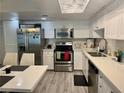 Well-lit kitchen featuring white cabinets, stainless steel appliances and modern finishes at 5474 S Maryland Pkwy, Las Vegas, NV 89119
