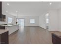 Open-concept living area boasts sleek tile flooring and abundant natural light from many windows at 701 Webber Park St, Henderson, NV 89011