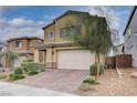 Beautiful two-story house featuring a spacious driveway and desert landscaping at 7109 Red Gulch St, North Las Vegas, NV 89084
