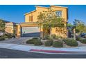 Beautiful two-story home with desert landscaping, a paved brick driveway, and a two-car garage at 7702 Wishbone Falls St, North Las Vegas, NV 89084