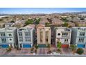 Attractive townhomes with a modern facade, desert landscaping, and rooftop terraces in a suburban neighborhood at 8055 Haywood Estate Ave, Las Vegas, NV 89113