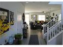 Bright foyer with wood-look tile flooring, staircase, and decorative accents at 8131 Skye Plum St, Las Vegas, NV 89166