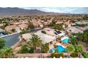 Stunning aerial view of a home with a pristine pool and lush landscaping in a beautiful neighborhood at 8633 Kennedy Heights Ct, Las Vegas, NV 89131