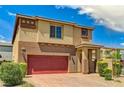 Two-story home with tan and brown exterior, brick driveway, and well maintained front yard at 934 Twincrest Ave, North Las Vegas, NV 89032