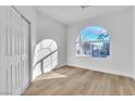 Bright bedroom featuring a closet and large arched window offering natural light at 10200 Wood Work Ln, Las Vegas, NV 89135
