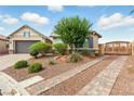 Charming single-story home featuring a well-maintained front yard with desert landscaping and a two-car garage at 10302 Artful Stone Ave, Las Vegas, NV 89149