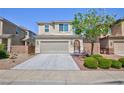 Inviting two-story home featuring a spacious driveway and desert landscaping at 1037 Water Cove St, Henderson, NV 89011