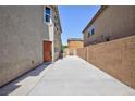 Wide side yard featuring privacy wall, access gate and concrete patio at 1037 Water Cove St, Henderson, NV 89011