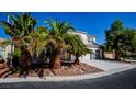 Two-story house featuring a three-car garage, well-maintained landscaping, and a rock-covered yard at 105 Chateau Whistler Ct, Las Vegas, NV 89148