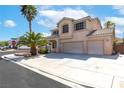 Beautiful two-story home with mature palm trees, a three-car garage and picturesque curb appeal at 1063 Silver Star St, Henderson, NV 89002