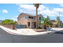 Beautifully landscaped home featuring mature palm trees, a security gate and inviting curb appeal at 1063 Silver Star St, Henderson, NV 89002