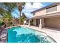 Inviting backyard pool with a Baja step, covered patio, and lush landscaping creating a private oasis at 1063 Silver Star St, Henderson, NV 89002