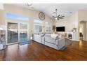 Open-concept living room featuring hardwood floors, clerestory windows, and a fireplace for cozy evenings at 10638 La Spezia Way, Las Vegas, NV 89141