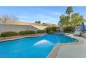 Backyard pool with a spa, surrounded by desert landscaping and a privacy wall, perfect for outdoor relaxation at 10638 La Spezia Way, Las Vegas, NV 89141