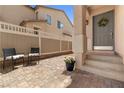 Inviting front porch area with a brick ground covering and neutral paint colors at 1165 Cactus Rock St, Henderson, NV 89011