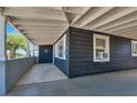 Covered patio offering protection from the elements is attached to the home's gray plank exterior at 21 Laswell St, Henderson, NV 89015