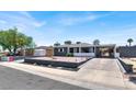 Single-story home with covered parking, gray facade, white trim, and easy-care desert landscaping at 21 Laswell St, Henderson, NV 89015