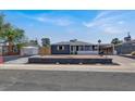 Quaint one-story home featuring a covered parking area and minimal desert-style landscaping at 21 Laswell St, Henderson, NV 89015