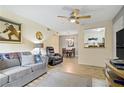 Inviting living area with wood-look floors, comfortable seating, and an open view to the kitchen at 220 Mission Newport Ln # 105, Las Vegas, NV 89107