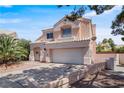 Charming two-story home shows a well-maintained yard and driveway, with desert landscaping at 2500 Cortina Ave, Henderson, NV 89074