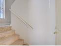Carpeted staircase with a white handrail leading to the upper level of the home at 2801 N Rainbow Blvd # 273, Las Vegas, NV 89108
