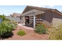 Cozy covered patio with outdoor seating and desert landscaping, perfect for relaxing or entertaining at 3088 Evening Mist Ave, Henderson, NV 89052