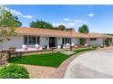 Charming home featuring a well-manicured front yard with lush lawn, seating, and inviting curb appeal at 3108 Sonia Dr, Las Vegas, NV 89107