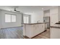Bright kitchen featuring an island, stainless steel appliances, and wood floors at 3219 Timorasso Ave, Henderson, NV 89044